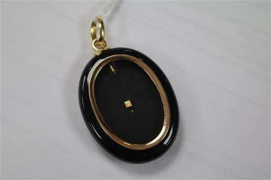 A Victorian gold, rose cut diamond and ruby set black enamel oval pendant locket, 49mm.